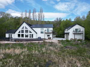 Back of property featuring a metal roof and a garage