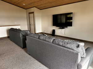Living area with wooden ceiling and crown molding