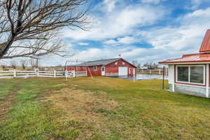 View of yard with an outbuilding, a detached garage, and driveway