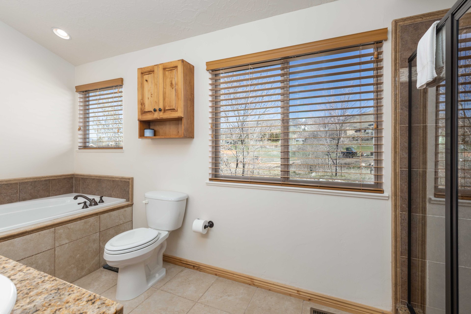 Full bathroom featuring light tile patterned floors, a bath, and vanity