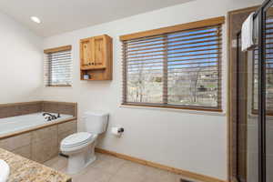Full bathroom featuring light tile patterned floors, a bath, and vanity