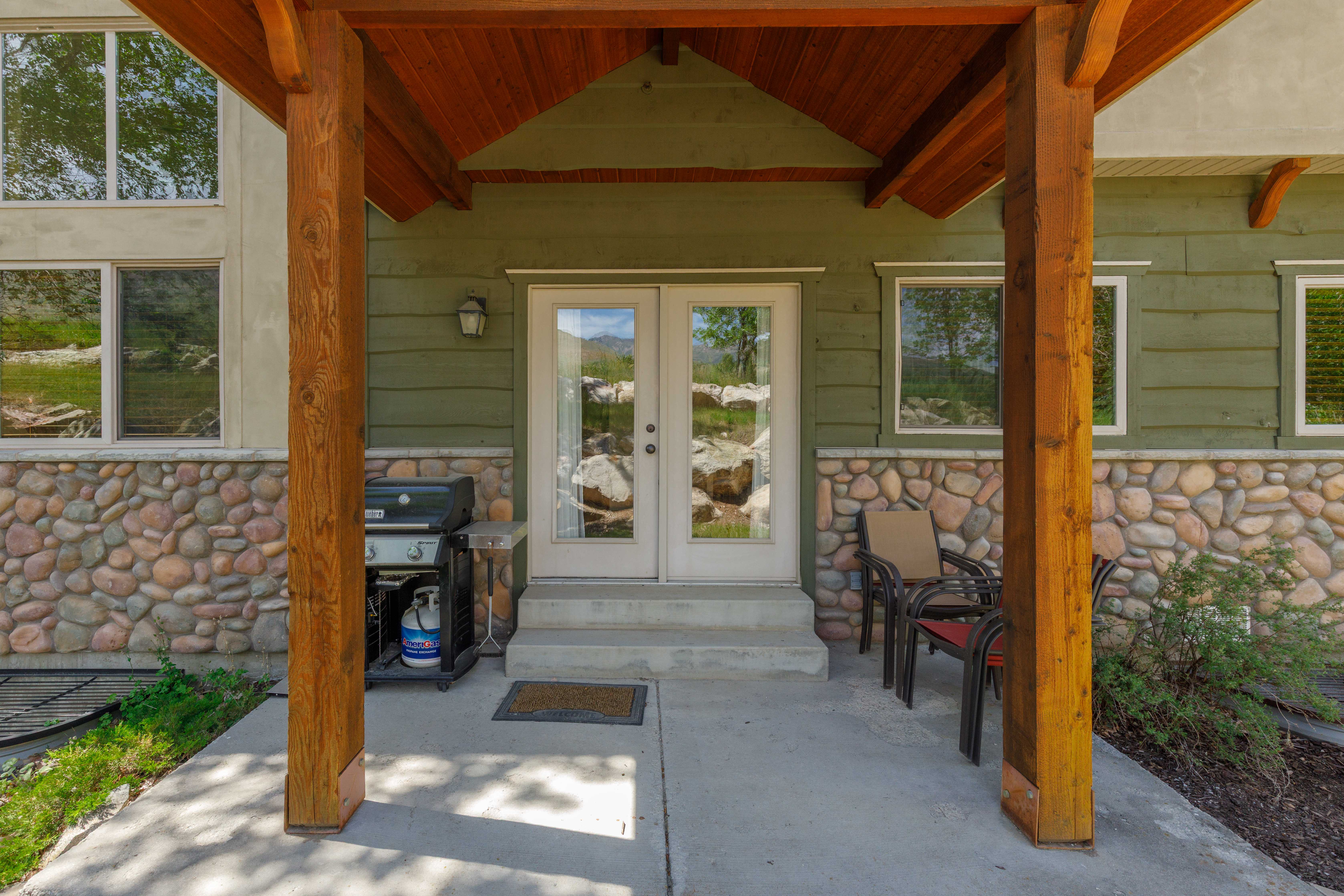 Covered entry with wood-finish structural beams and tongue-and-groove ceiling