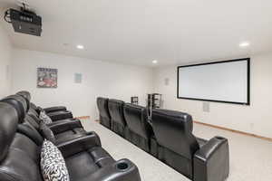 Cinema featuring light carpet and recessed lighting