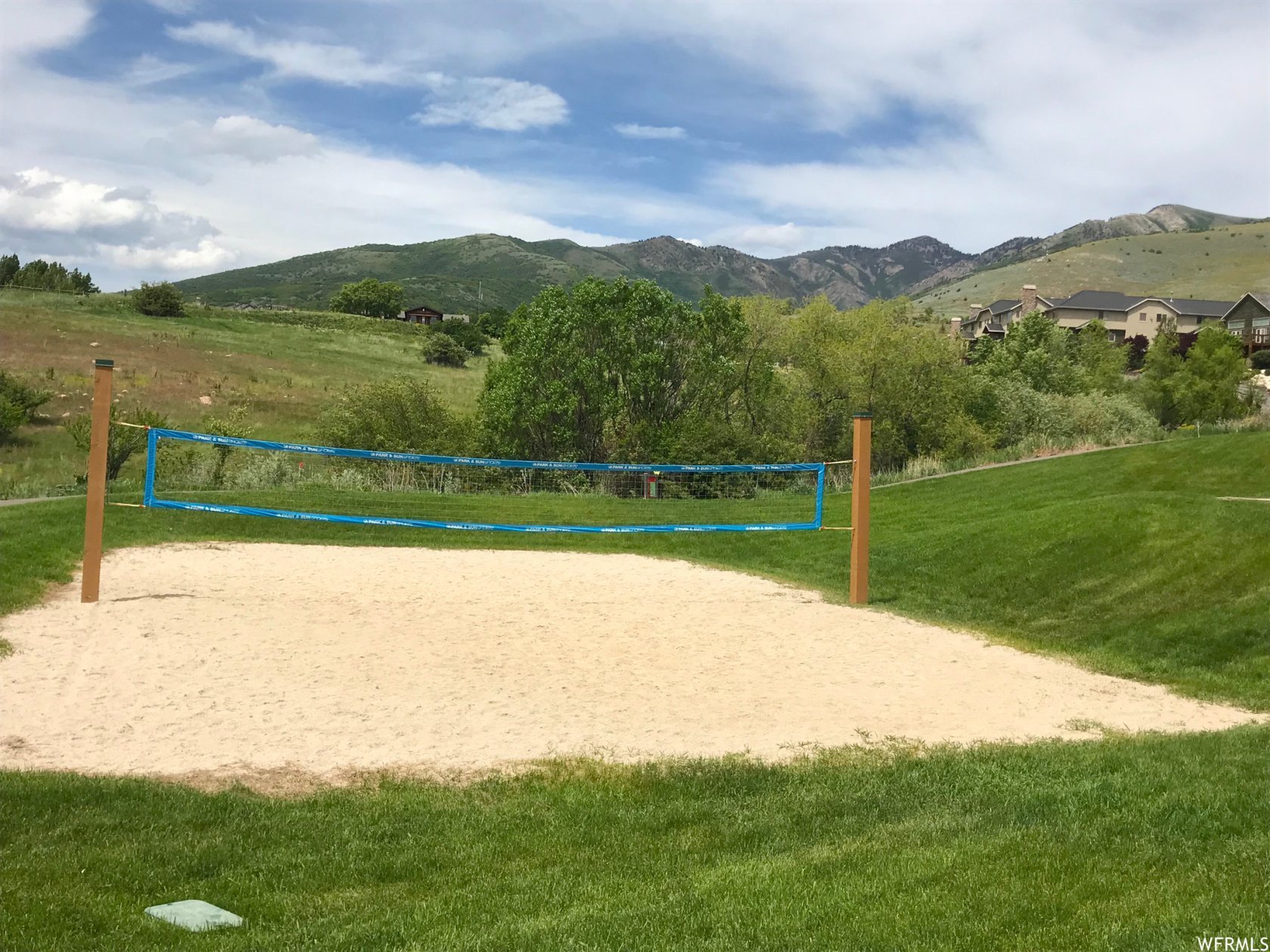 View of community with volleyball court, a mountain view, and a view of rural / pastoral area