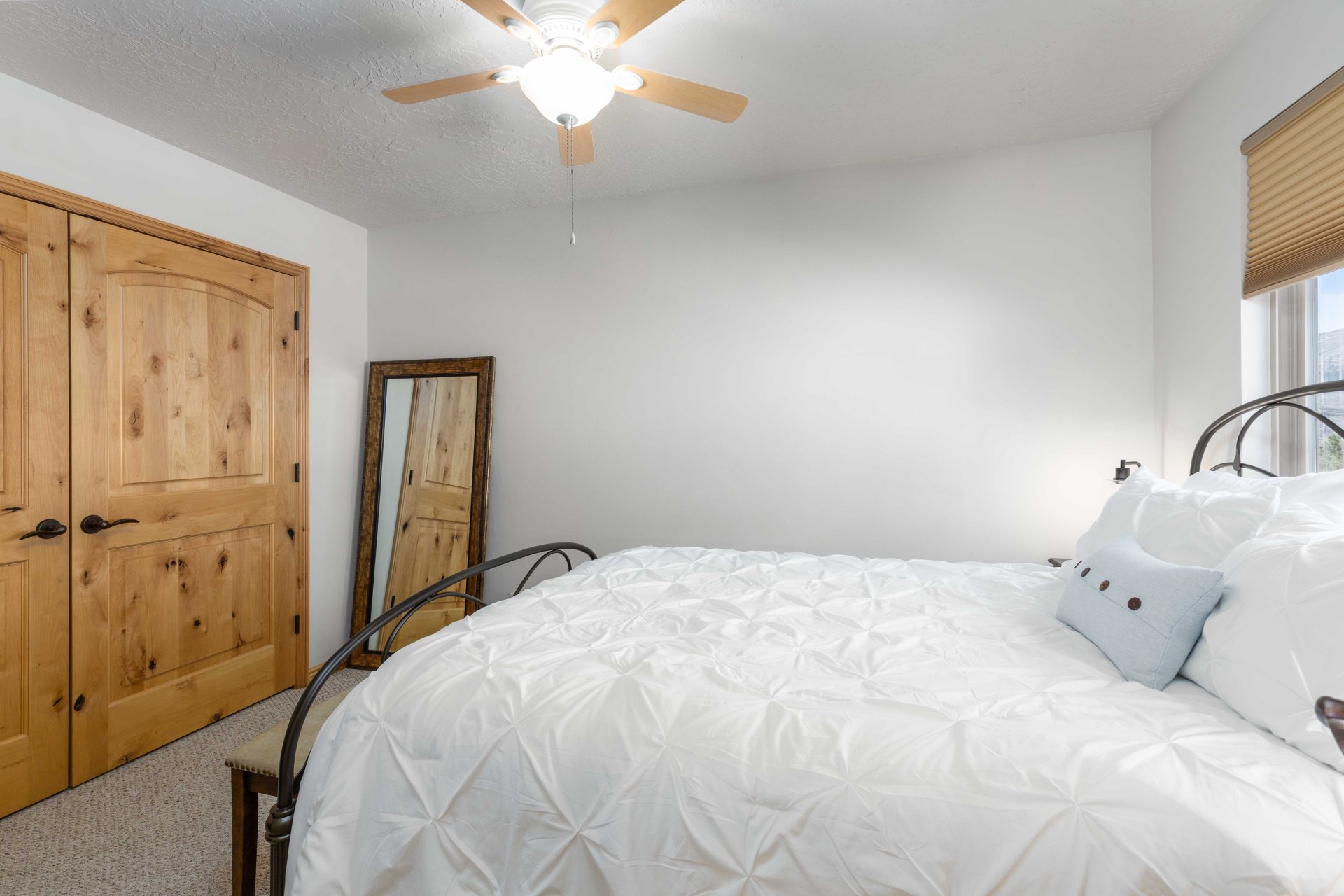 Bedroom with carpet, ceiling fan, and a textured ceiling
