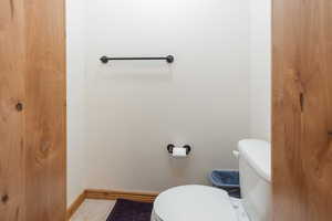 Bathroom with toilet and baseboards