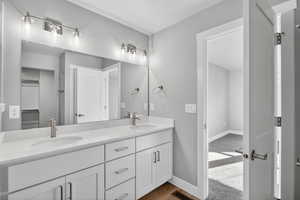 Bathroom featuring double vanity and light wood-type flooring