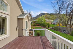 Wooden deck featuring a mountain view and a residential view