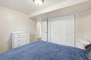 Bedroom featuring a closet and a textured ceiling