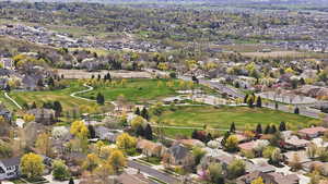Aerial overview of property's location featuring nearby suburban area and a golf course