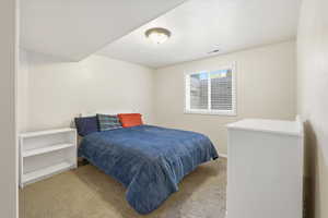 Bedroom with carpet flooring and a textured ceiling