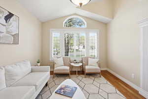 Living area featuring light wood floors and baseboards