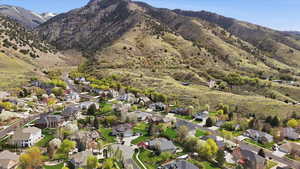 Aerial perspective of suburban area featuring a mountain backdrop