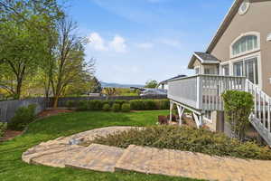 Fenced backyard with a wooden deck