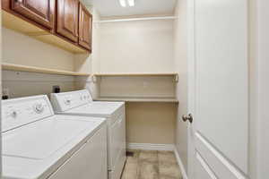Laundry room featuring cabinet space and washing machine and dryer
