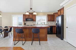 Kitchen featuring wood finish cabinets, a breakfast bar, and a center island
