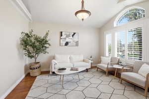 Living room with wood finished floors and lofted ceiling