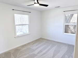 Spare room with light carpet and ceiling fan