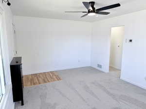 Unfurnished room with light carpet and ceiling fan