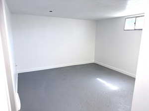 Empty room with baseboards and concrete floors