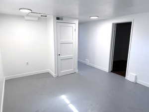 Unfurnished room featuring baseboards and concrete flooring