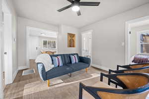 Living room featuring wood finished floors and a ceiling fan