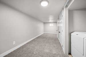 Basement with light colored carpet and baseboards