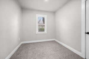 Unfurnished room featuring light colored carpet and baseboards