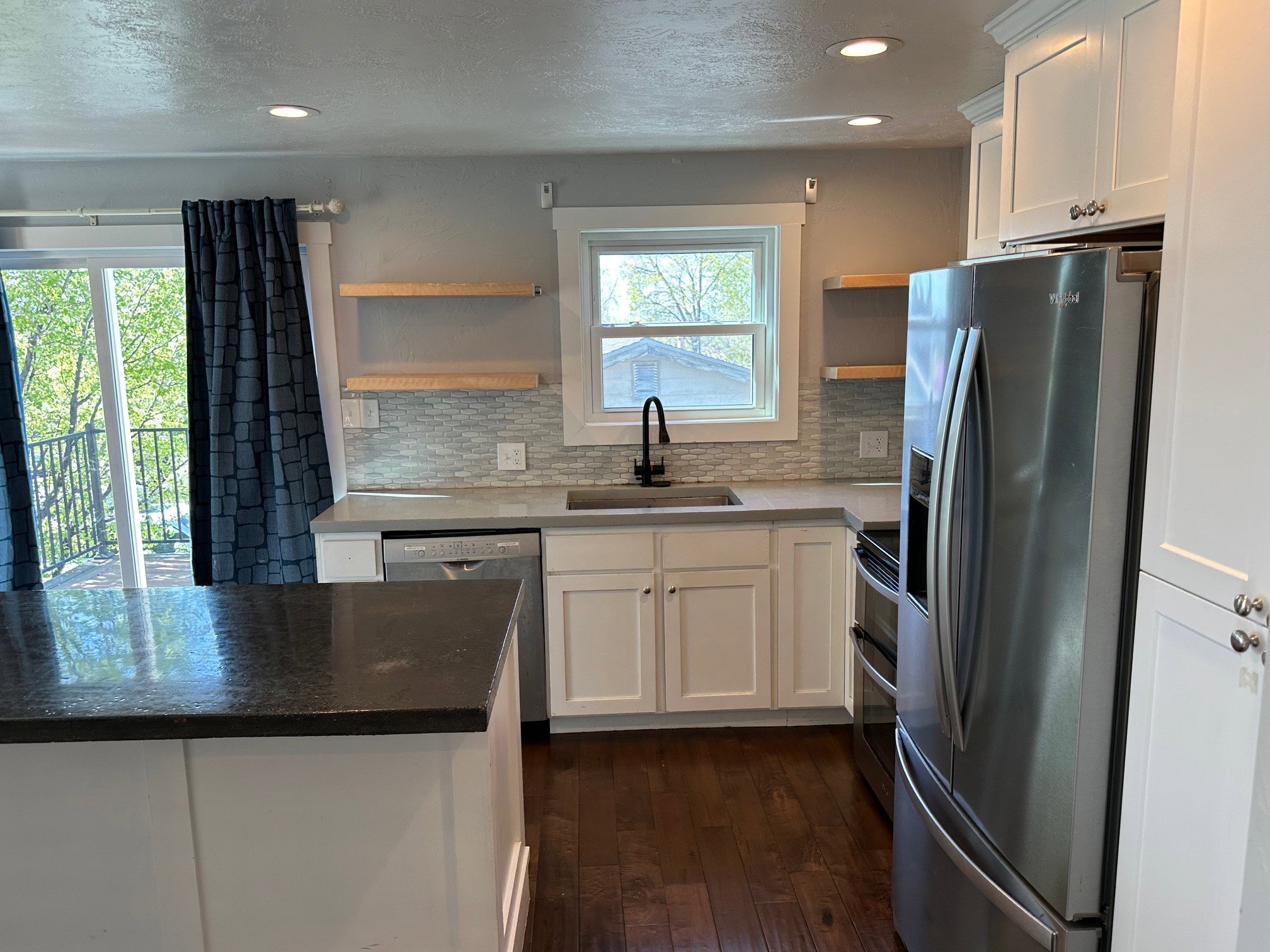 Kitchen featuring open shelves, white cabinets, stainless steel appliances, recessed lighting, and dark wood finished floors