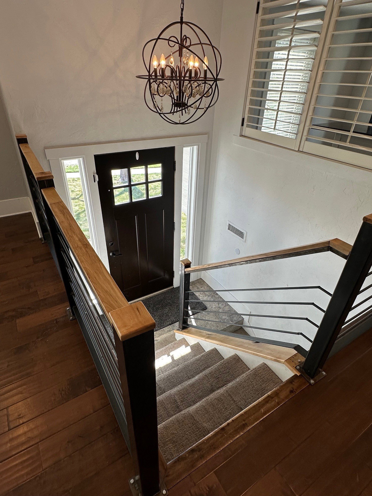 Entrance foyer featuring dark wood finished floors and suspended lighting
