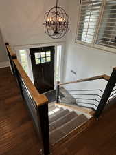 Entrance foyer featuring dark wood finished floors and suspended lighting