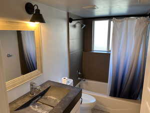 Bathroom with vanity and shower / bath combo with shower curtain