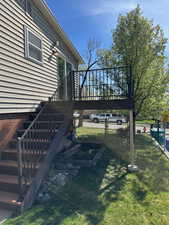 View of yard featuring stairway and a gate