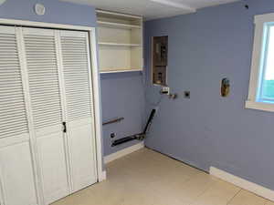 Laundry room featuring washer hookup, a textured ceiling, electric panel, and electric dryer hookup