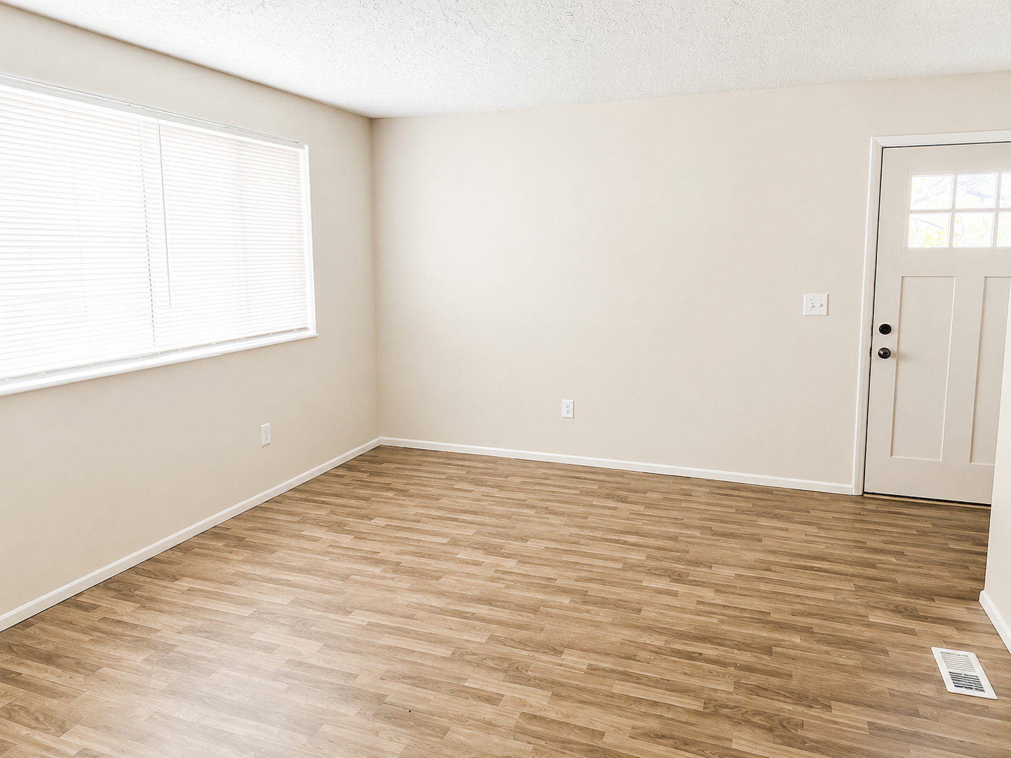 Entryway featuring wood-finish flooring and a window with blinds