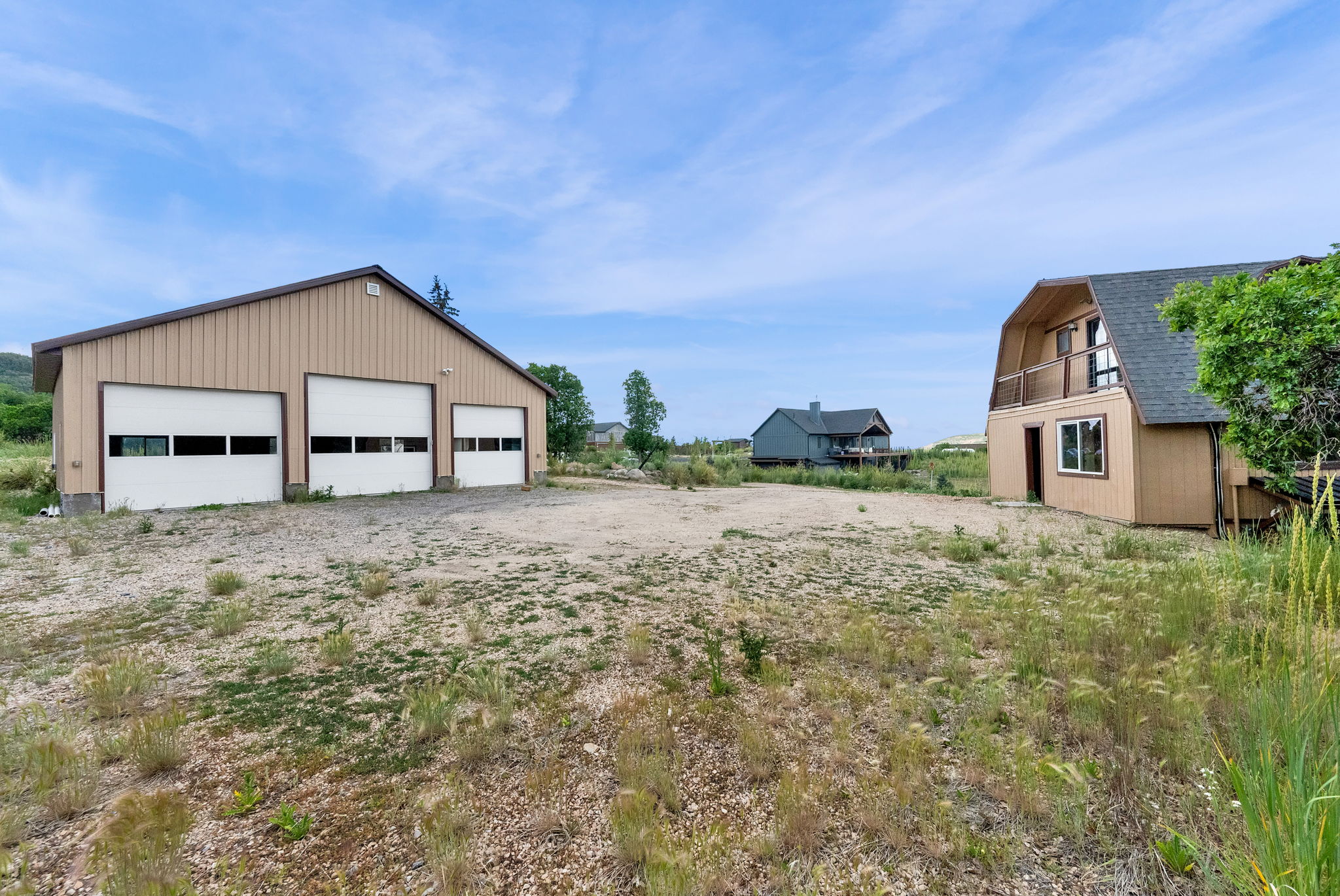 Three-bay garage building with two-story barn-style structure
