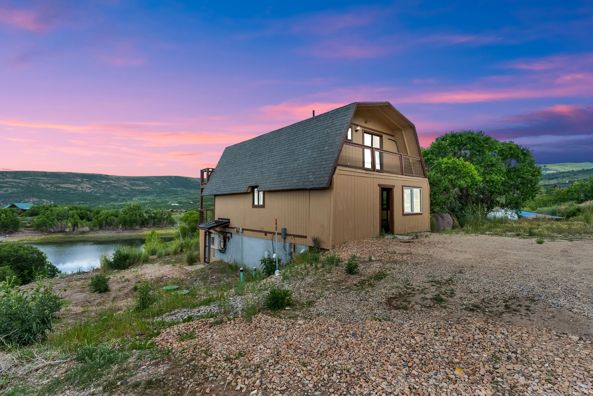 Unique gambrel-roof structure with a second-story balcony