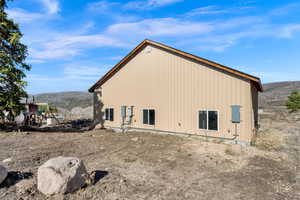 View of side of home with a mountain view