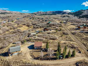 Aerial view of sparsely populated area featuring a mountainous background and a desert landscape