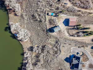 Aerial view of property and surrounding area featuring a nearby body of water
