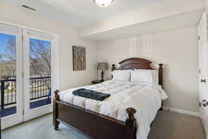 Carpeted bedroom with access to exterior
