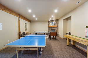 Playroom with a stone fireplace and recessed lighting