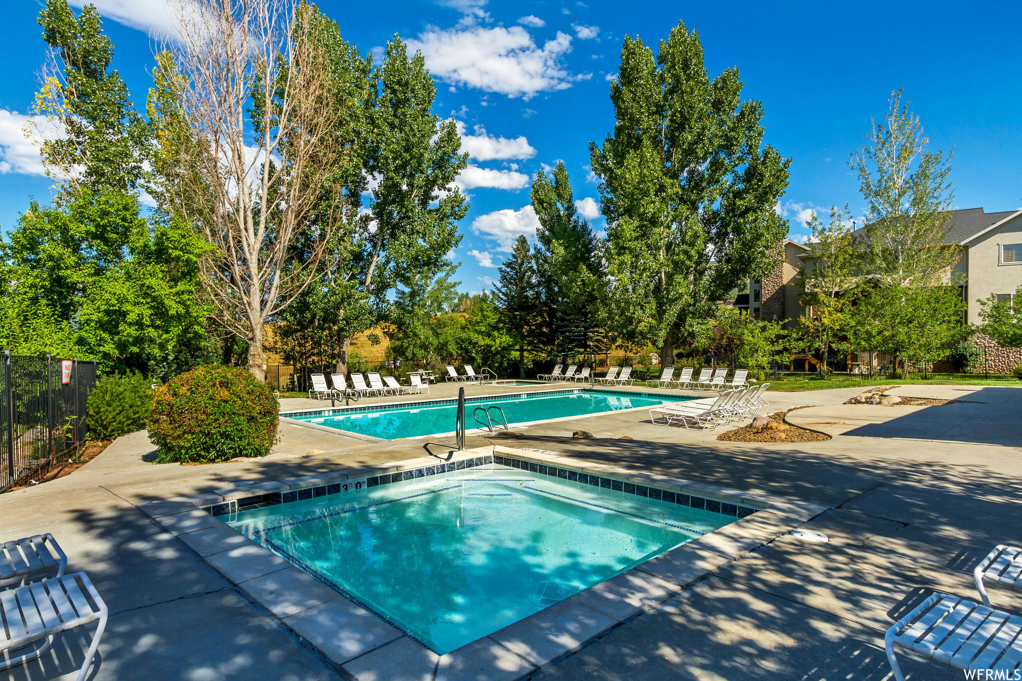Community pool featuring a patio and a community hot tub