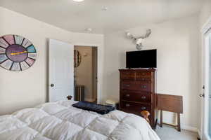 Carpeted bedroom featuring baseboards