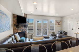 Living room featuring a stone fireplace