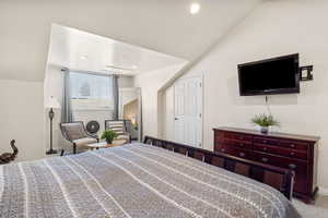 Bedroom with carpet flooring, vaulted ceiling, and recessed lighting