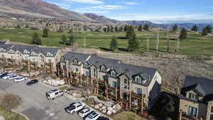Drone / aerial view of a mountain backdrop and a golf club