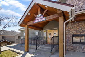 View of exterior entry featuring stone siding
