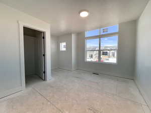 Unfurnished bedroom featuring baseboards and a textured ceiling
