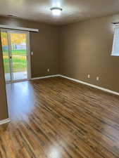 Spare room with dark wood finished floors and a textured ceiling